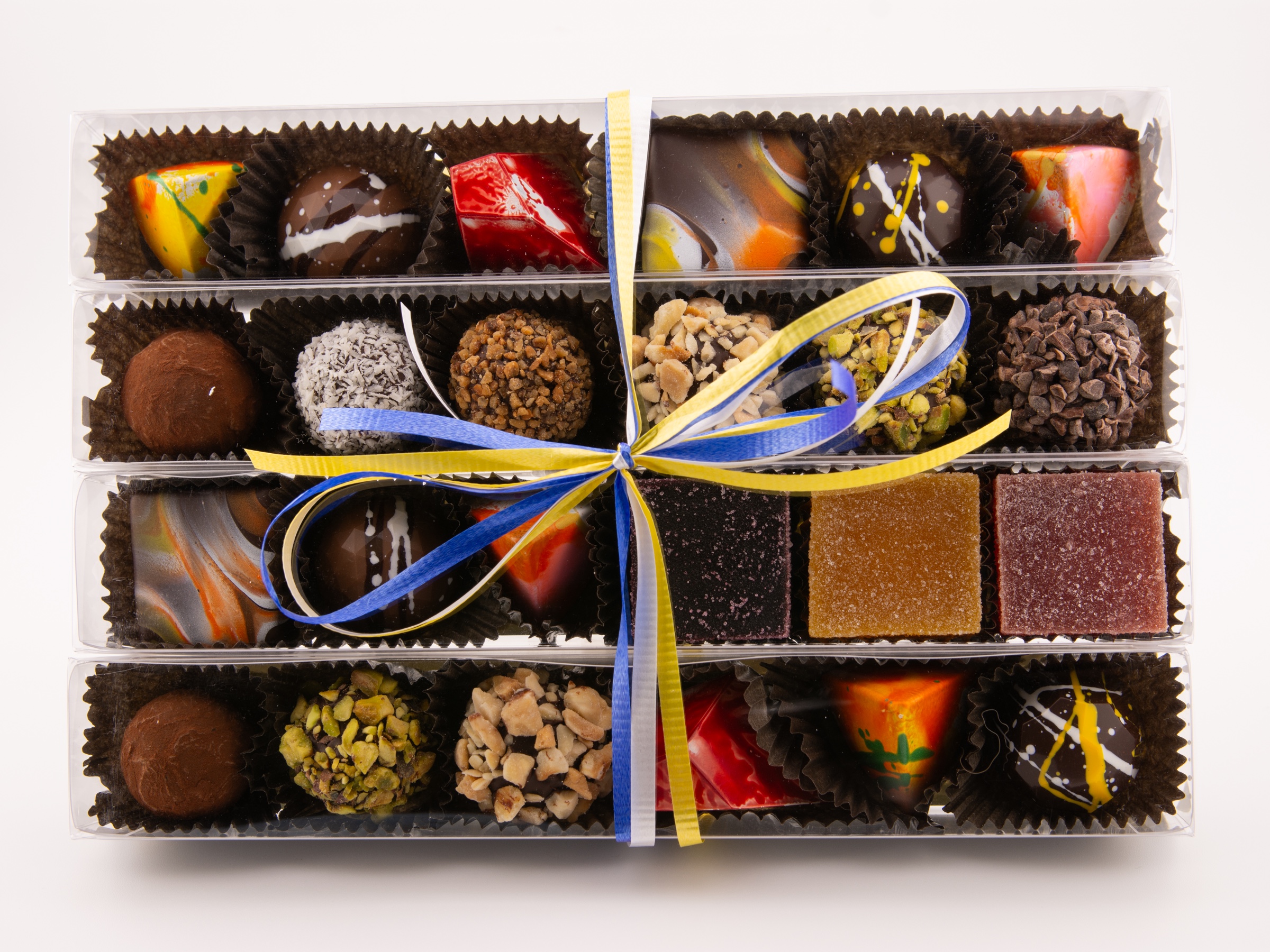Twenty-four Alpen confections in four six-piece clear boxes displayed side by side