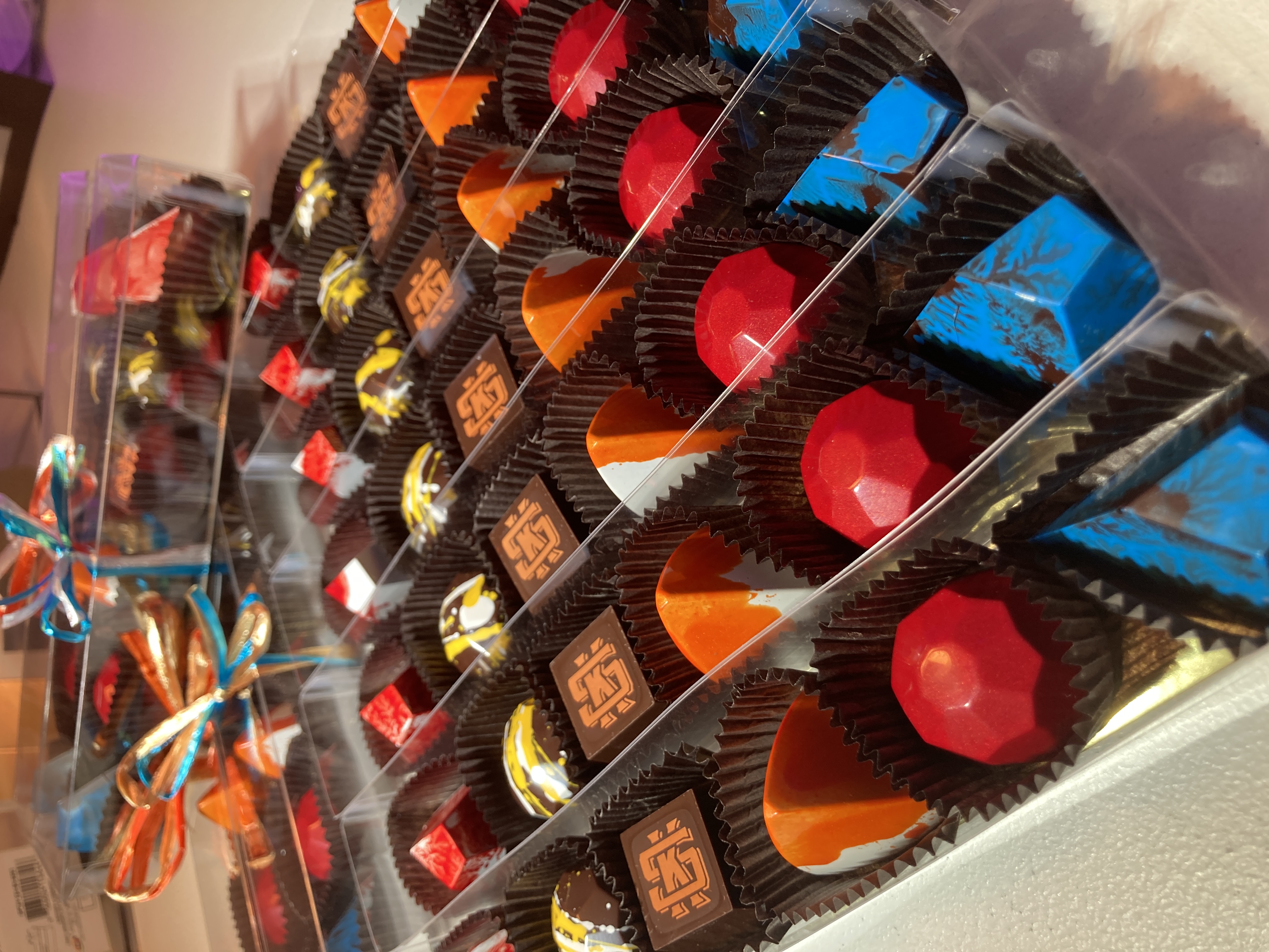 Actual Alpen bonbons arranged in long clear gift boxes with raffia ties